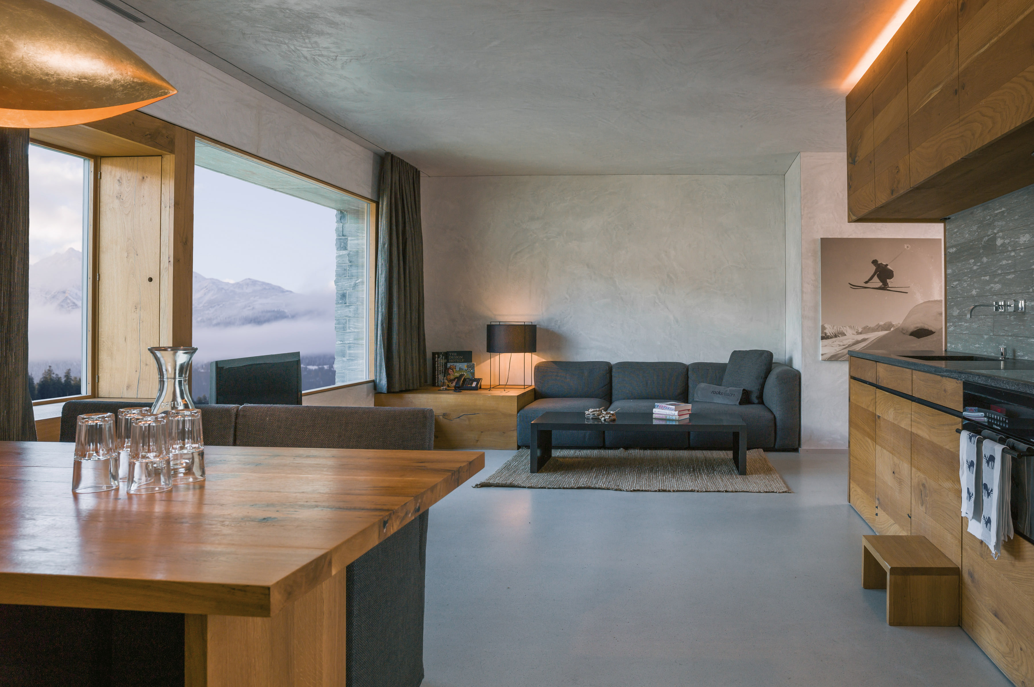 Stone apartment buildings and mountain landscape at rocksresort Laax